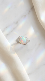 Natural Opal Ring - Arcana Aurora on marble and ivory silk flat lay