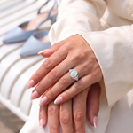 Model wearing Natural Opal Ring - Arcana Aurora, elegant crossed hands with ivory silk sleeves