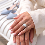 Model hands wearing Natural Opal Ring - Arcana Aurora with powder blue heels in background