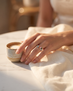 Lifestyle shot of model wearing natural tourmaline and diamond ring in golden hour light