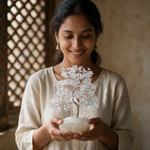 Woman holding the clear quartz crystal tree in an Indian home interior