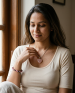 Woman wearing the rose quartz heart pendant and rhodonite bracelet from The Love Ritual