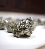 Raw pyrite cluster shown in hand for scale – Gift Palace India
